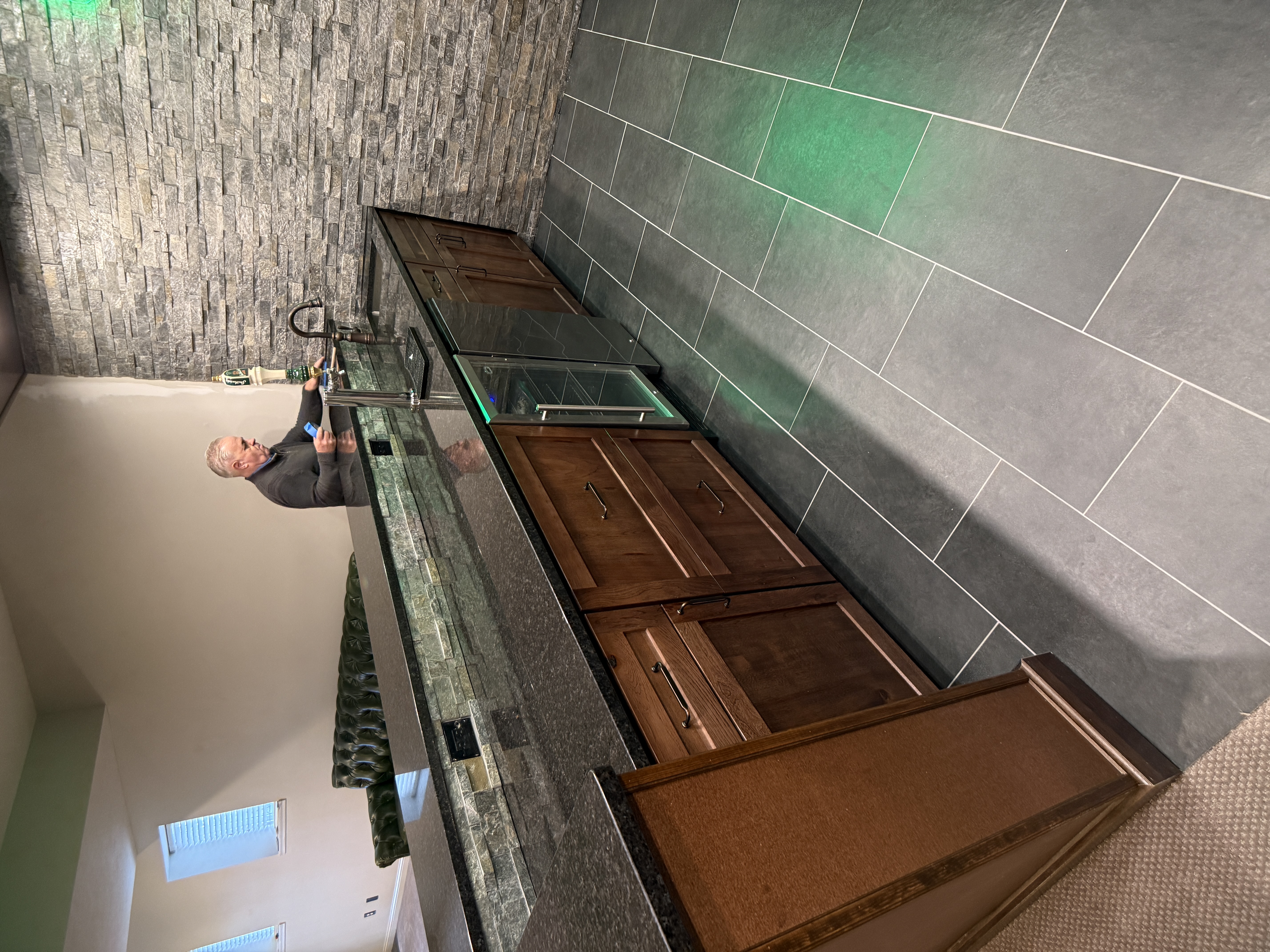 Finished basement bar with under-counter beverage coolers by Serge Construction